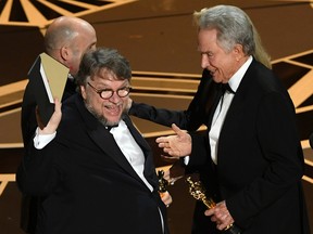 Director Guillermo del Toro accepts Best Picture for The Shape of Water from actor Warren Beatty onstage during the 90th Annual Academy Awards.