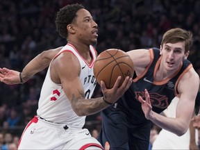 Raptors guard DeMar DeRozan, left, drives to the basket past Knicks forward Luke Kornet, right, during the first half NBA action, Sunday, March 11, 2018, at Madison Square Garden in New York.