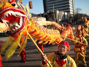 Members of the Essex County Chinese Canadian Association take part in a parade in downtown Windsor in November 2013.