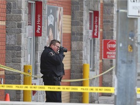 A Windsor Police officer take pictures at the McDonald's at Goyeau Street and Wyandottte Street on March 21, 2018 in Windsor. A man died after being involved in a shooting with the police.