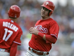Philadelphia Phillies' Andrew Knapp, right, celebrates with Rhys Hoskins after scoring on an RBI double by Nick Williams off Boston Red Sox starting pitcher Chris Sale during the third inning of a spring training baseball game Monday, March 19, 2018, in Fort Myers, Fla.