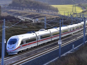 A special Inter City Express train of Deutsche Bahn, DB,drives along the new fast railway track between Munich and Berlin in Erfurt, Germany, Friday, Dec. 8, 2017. Deutsche Bahn said Friday the new line will shave up to two hours off the current trip between northeastern Germany and Bavaria with high-speed trains able to travel up to 300 kph (185 mph) and complete the journey in just under four hours. (Martin Schutt/dpa via AP) ORG XMIT: LGL208