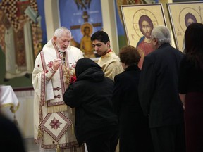 Archbishop Sotirios Athanassoulas holds the first Sunday mass at the Holy Cross Greek Orthodox Church on Walker Rdoad on March 11, 2018.