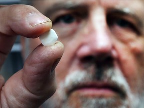 Dr. Tony Hammer is shown  on March 2, 2018 with a tablet of Suboxone used to treat opioid addiction.