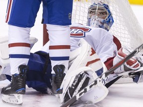 Montreal Canadiens goaltender Charlie Lindgren looks up at one of his defencemen during the second period of his team's 4-0 loss to the Toronto Maple Leafs in NHL hockey action in Toronto on 
March 17, 2018. One of the Leafs' goals was called back on a goalie interference call.