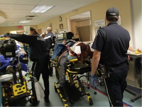 EMS paramedics, patients and emergency room staff navigate through a jam packed hallway at Windsor Regional Hospital in this file photo.