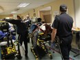 EMS paramedics, patients and emergency room staff navigate through a jam packed hallway at Windsor Regional Hospital in this file photo.