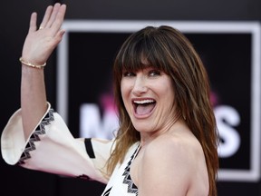 Kathryn Hahn, a cast member in "Bad Moms," waves to photographers at the premiere of the film at the Mann Village Theatre on July 26, 2016, in Los Angeles.