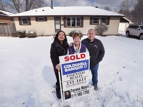 Teresa Macri, left, a real estate agent with Caldwell Banker, with Tammy and Dennis Lenz at their home at 567 Laurier Dr. in LaSalle on March 2, 2018. Macri sold the couple's house for $65,200 over the asking price after receiving 29 offers.