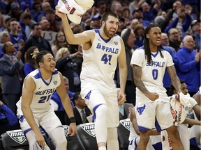 Catholic Central high school product Dominic Johnson (21) is making an unexpected trip to the NCAA men's basketball tournament with the University of Buffalo Bulls.