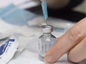 Manitoba school boards have overwhelmingly voted against lobbying the provincial government to make vaccines mandatory for children going to schools. A dose of flu vaccine is drawn up to a syringe, in Montreal on Dec. 5, 2017.