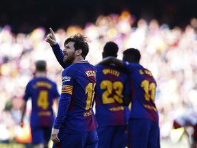 FC Barcelona's Lionel Messi, left, celebrates after scoring during the Spanish La Liga soccer match between FC Barcelona and Athletic Bilbao at the Camp Nou stadium in Barcelona, Spain, Sunday, March 18, 2018.