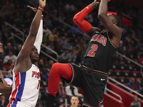 Chicago Bulls guard Jerian Grant, right, shoots as Detroit Pistons guard Reggie Jackson, left, defends during the first half of an NBA basketball game, Saturday, March 24, 2018, in Detroit.