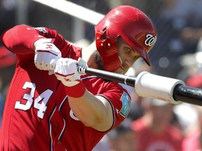 Washington Nationals' Bryce Harper swings in the on-deck circle as he prepares to bat during the fourth inning of an exhibition spring training baseball game against the Houston Astros on March 3, 2018, in West Palm Beach, Fla.