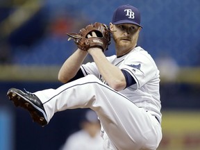 FILE - In this Sept. 4, 2017, file photo, Tampa Bay Rays' Alex Cobb goes into his windup during the first inning of a baseball game against the Minnesota Twins in St. Petersburg, Fla. Cobb, a free agent, and the Baltimore Orioles have finalized a four-year contract. The 30-year-old righty was 12-10 with a 3.66 ERA in 29 starts for Tampa Bay last season.