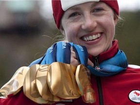 Lauren Woolstencroft of Canada holds up her five gold medals that she won during the 2010 Winter Paralympic Games in Whistler, March 20, 2010. Woolstencroft has received hundreds if not thousands of messages since her remarkable life story was broadcast to the world during the Super Bowl.