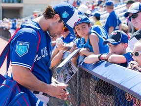 Toronto Blue Jays fielder Randal Grichuk signs autographs for fans prior to a spring training game in Dunedin on Feb. 25, 2018
