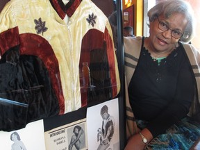 Ramona Isbell talks about her days as a professional wrestler in the 1960s and 1970s beside a framed collage of mementos including publicity photos and a jacket, on Monday, March 19, 2018, in Columbus, Ohio. A new documentary tells the story of black women professional wrestlers in the 1950s and 1960s, many of them from Columbus.