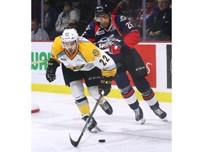 Windsor Spitfires forward Cole Purboo, at right, chases down Sarnia Sting defenceman Mitch Eliot during Game 3 on Tuesday at the WFCU Centre.