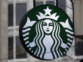 FILE - This March 14, 2017, file photo show the Starbucks logo on a shop in downtown Pittsburgh. Starbucks is making a $10 million commitment to develop a greener coffee cup that is fully recyclable and compostable, the company announced on March 20, 2018.