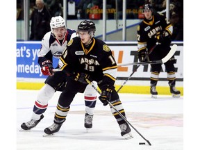 Sarnia Sting forward Ryan McGregor (19) is chased by Windsor Spitfires' forward Curtis Douglas (39) during earlier series action at Progressive Auto Sales Arena. (Mark Malone/Chatham Daily News/Postmedia Network)