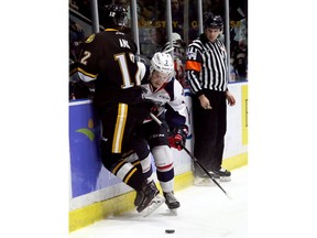 Windsor Spitfires' Tyler Angle (7) hits Sarnia Sting's Jonathan Ang (12) in the first period of Friday's Game 5 in their OHL Western Conference quarter-final at Progressive Auto Sales Arena in Sarnia. (Mark Malone/Chatham Daily News/Postmedia Network)