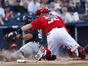 Detroit Tigers' Miguel Cabrera (24) is tagged out by Washington Nationals catcher Matt Wieters (32) as he tries to score on a Jim Adduci base hit in the first inning of a spring training baseball game on  March 4, 2018, in West Palm Beach, Fla.