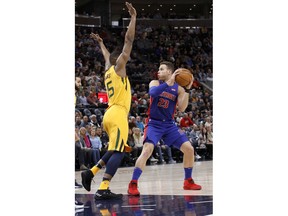 Detroit Pistons' Blake Griffin (23) looks to pass as Utah Jazz's Derrick Favors, left, defends in the first half of an NBA basketball game on Tuesday, March 13, 2018, in Salt Lake City.