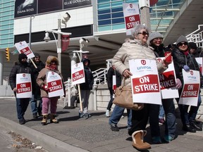 Striking Caesars Windsor workers with Unifor Local 444 walk the picket line on Chatham Street East on April 7,  2018.