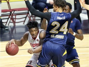 Windsor Express Shaquille Keith takes the low road against St. John Edge Charles Hinkle in NBL Canada playoff action from WFCU Centre in Windsor on Wednesday.