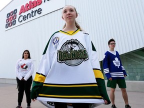Graydon Ribchester, a Grade 9 student at Belle River High District High School, wears her authentic Humboldt Broncos hockey jersey at the Atlas Tube Centre in Lakeshore on April 12, 2018. Fellow students Maria Kolonelos, left, and Stewart MacDonald helped raise money for the Humboldt GoFundMe campaign.
