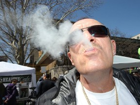 Medicinal cannabis user Paul Leblanc exhales during 4-20 event at Charles Clark Square.