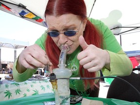 Dawn Foley demonstrates 'dabbing' (inhaling vapours) during Friday's 4/20 event at Charles Clark Square.