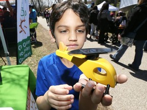 Yahya Abdelhady, 8, examines a solar-powered toy helicopter during Earth Day activities at Malden Park in Windsor on April 22, 2018.