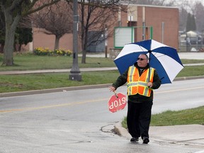 Crossing guard Steve Piper crosses Victoria Street near the former St. Bernard Catholic Elementary School on Richmond Street on April 24, 2018.  The Town of Amherstburg has purchased the property.