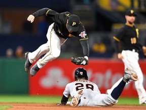 Niko Goodrum of the Detroit Tigers safely steals second base as Max Moroff of the Pittsburgh Pirates misses the throw in the second inning during game two of a doubleheader at PNC Park on April 25, 2018 in Pittsburgh, Pennsylvania.