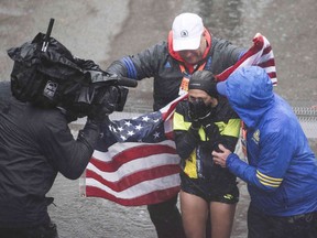 Desiree Linden of the US celebrates after crossing the finish line as the winner of the 2018 and 122nd Boston Marathon for Elite Women's race with a time of 2:39:5.in Boston, Massachusetts.  Her personal best finish was previously second place in the Boston Marathon in 2011 with a time of 2:22:38.