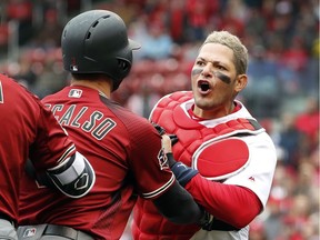 St. Louis Cardinals catcher Yadier Molina, right, is held back by Arizona Diamondbacks' Daniel Descalso while yelling at Diamondbacks manager Torey Lovullo during the second inning of a baseball game on April 8, 2018, in St. Louis.