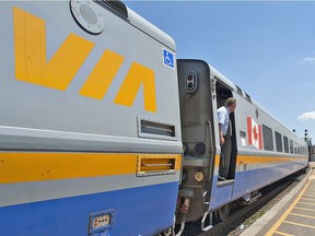 A VIA Rail employee makes one final check for passengers as a westbound VIA Rail train prepares to depart its station stop at Brantford on July 6, 2011.
