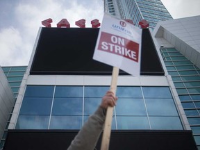 A worker raises his strike placard at Caesars Windsor on April 9, 2018.