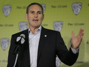 FILE - In this Oct. 12, 2017, file photo, Pac-12 commissioner Larry Scott gestures while speaking a NCAA college basketball Pac-12 media day, in San Francisco. A Pac-12 task force on reforming college basketball is recommending an end to the NBA's one-and-done rule, allowing players to return to school even after they are drafted, and that the NCAA facilitate access to agents for high school players. The Pac-12 announced the recommendations from its task force on Tuesday, March 13, 2018, and its report has been sent to the NCAA's commission on college basketball, headed by former Secretary of State and Stanford University Provost Condoleezza Rice.