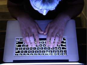 A man looks at a computer screen.