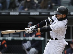 Chicago White Sox's Yolmer Sanchez hits a two-run triple during the first inning of the White Sox home-opener baseball game against the Detroit Tigers, Thursday, April 5, 2018, in Chicago.