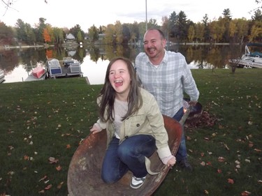 Amanda has some wheelbarrow fun with dad.