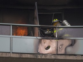 Windsor fire crews work to put out a condo fire on the 12th floor of the Le Goyeau condominium building at 111 Riverside Dr. East, Tuesday, April 17, 2018.