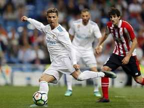 Real Madrid's Cristiano Ronaldo shoots the ball during a Spanish La Liga soccer match between Real Madrid and Athletic Bilbao at the Santiago Bernabeu stadium in Madrid, Wednesday, April 18, 2018.