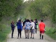 Students from nearby Sainte-Ursule Elementary School take a walk on The Cypher Systems Group Greenway after the trail official opened Aril 27, 2017.