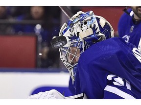 Using his head. Toronto Maple Leafs goaltender Frederik Andersen (31) takes a puck off his helmet during third period NHL round one playoff hockey action against the Boston Bruins in Toronto on April 23, 2018. Leafs won the game 3-1, tying the best-of-seven series 3-3.