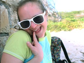 Amanda Lassaline is shown being silly on the beach in Antigua.