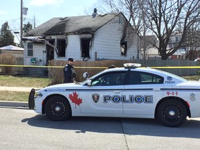 Police keep watch over a fire scene on Vimy Avenue on April 8, 2018.